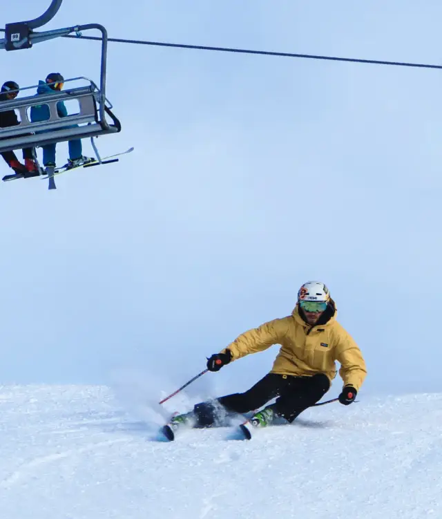 Skier carving a turn on a groomed piste